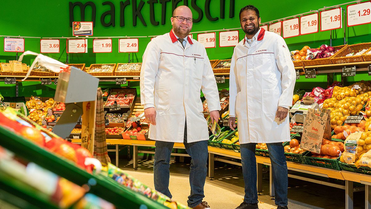 Zwei famila Mitarbeiter die im famila Supermarkt stehen.